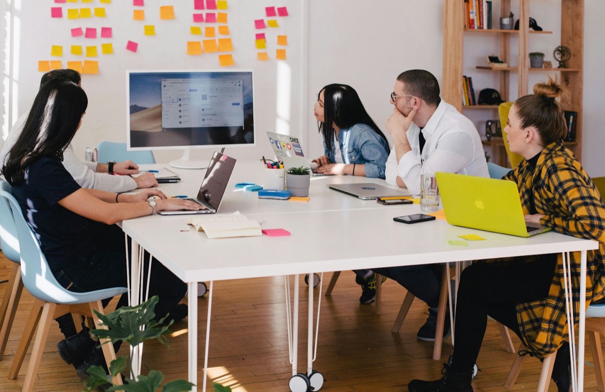 A team gathered around a table in a focus group discussion